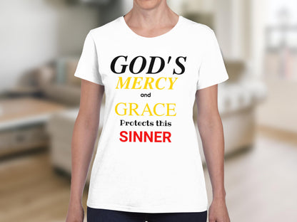 White t-shirt with text "GOD'S MERCY and GRACE Protects this SINNER".