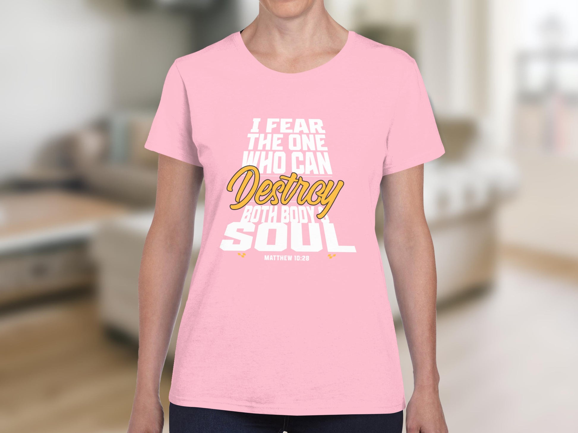 Pink t-shirt with white and yellow text reading "I fear the one who can destroy both body and soul. Matthew 10:28".