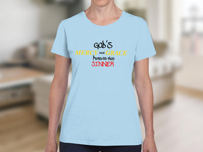 Light blue t-shirt with "God's Mercy and Grace Protects this Sinner" text.