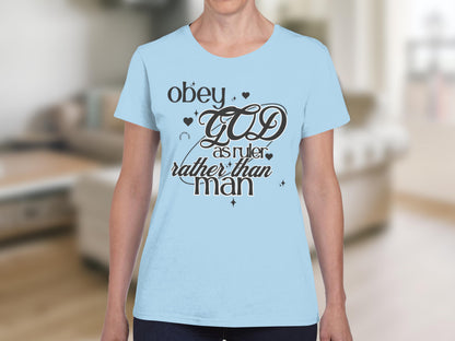 Light blue t-shirt with "Obey God as ruler rather than man" text design.