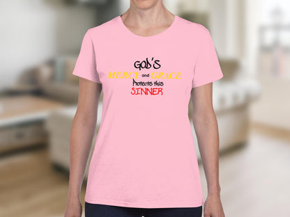 Pink t-shirt with "God's Mercy and Grace Protects this Sinner" text.