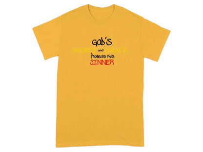 Yellow t-shirt with "God's Mercy and Grace Protects this Sinner" text.