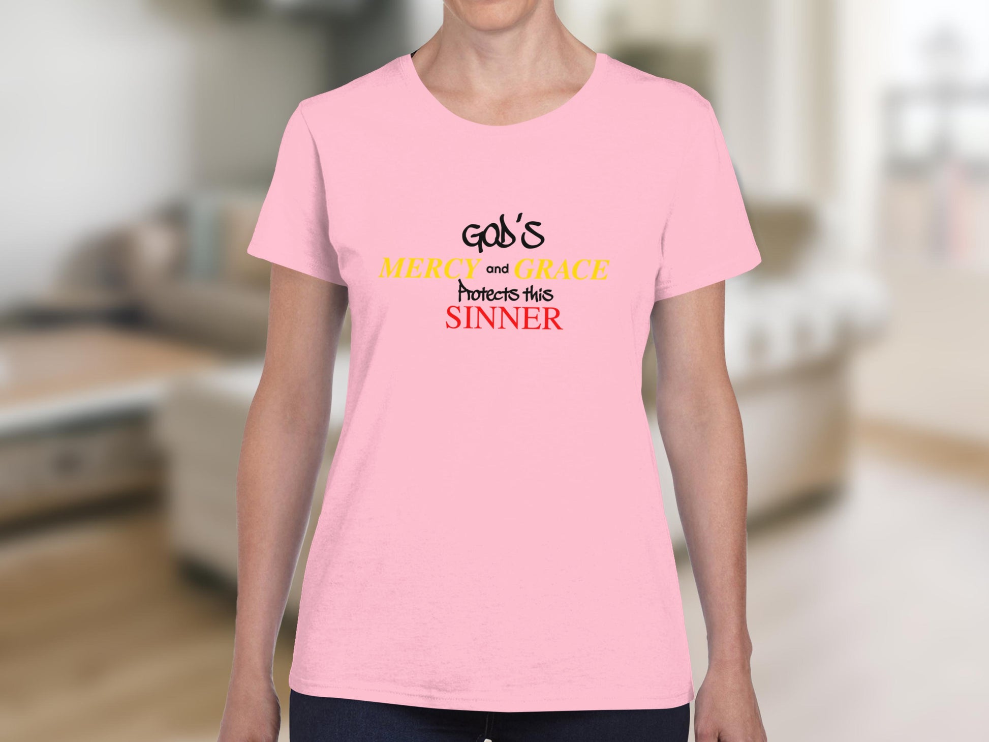 Pink t-shirt with text "God's Mercy and Grace Protects This Sinner".