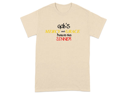 Cream t-shirt with "God's Mercy and Grace Protects this Sinner" text.