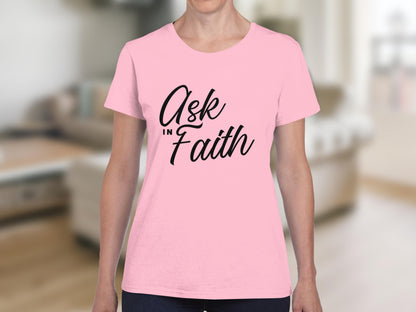 Pink t-shirt with "Ask in Faith" text on a blurred background.